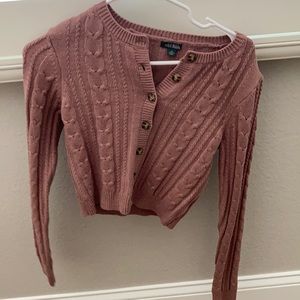 pinkish long sleeve top.